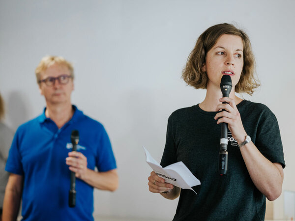 Tiphaine Cattiau, curator of the exhibition, gives a speech.