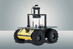 Zu sehen ist ein 4rädriger Roboter in schwarz und gelb. Oben befindet sich Platz für einen Aufsatz, z.B. einen Wassertank.