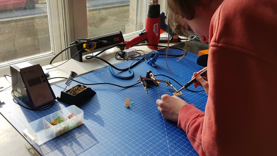a kid working on a measuring device