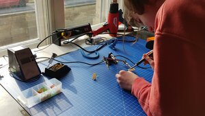 a kid working on a measuring device