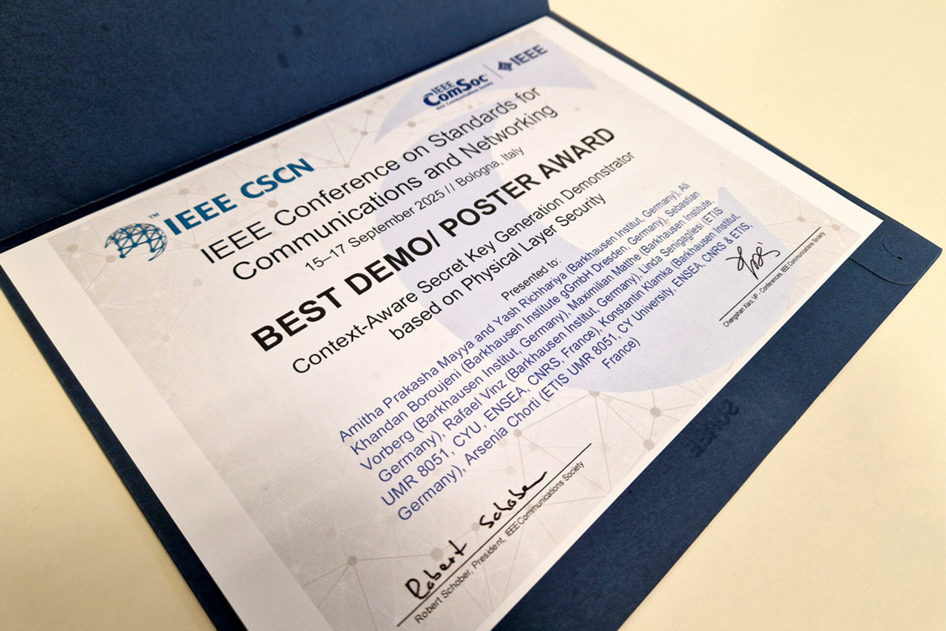 Certificate titled 'Best Demo/Poster Award' from IEEE CSCN Conference on Standards for Communications and Networking, dated 15-17 September 2025, awarded to Amitha Prakasha Mayya and Yash Richhariya plus their team for the Context-Aware Secret Key Generation Demonstrator based on Physical Layer Security.