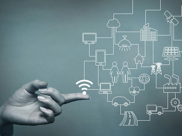 On the left side you can see a hand reaching into the picture. The index finger is outstretched. On the right-hand side you can see various symbols related to IoT in white. They are connected by lines. The background is a dirty green colour.