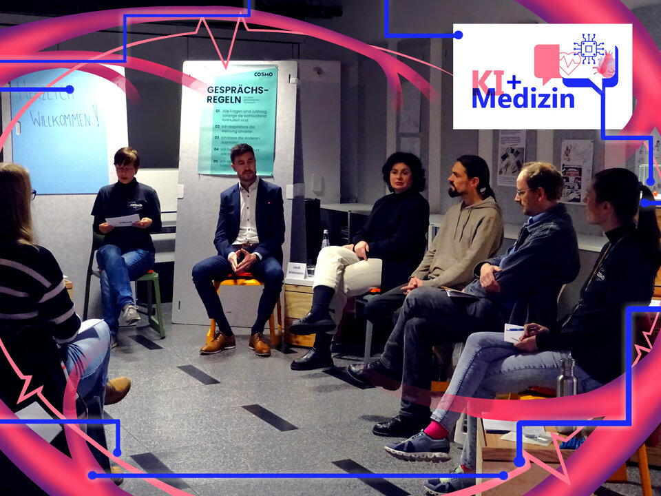 People sit in a circle of chairs and discuss the topic of AI in medicine
